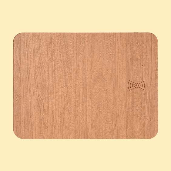 Wireless Charging Desk Mat in brown wood-grain finish, top view, with the embossed charging icon near the right edge