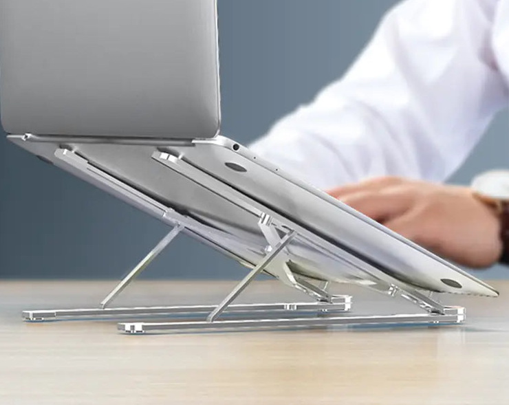 Aluminum Laptop Stand holding a laptop raised above a desk while a person types