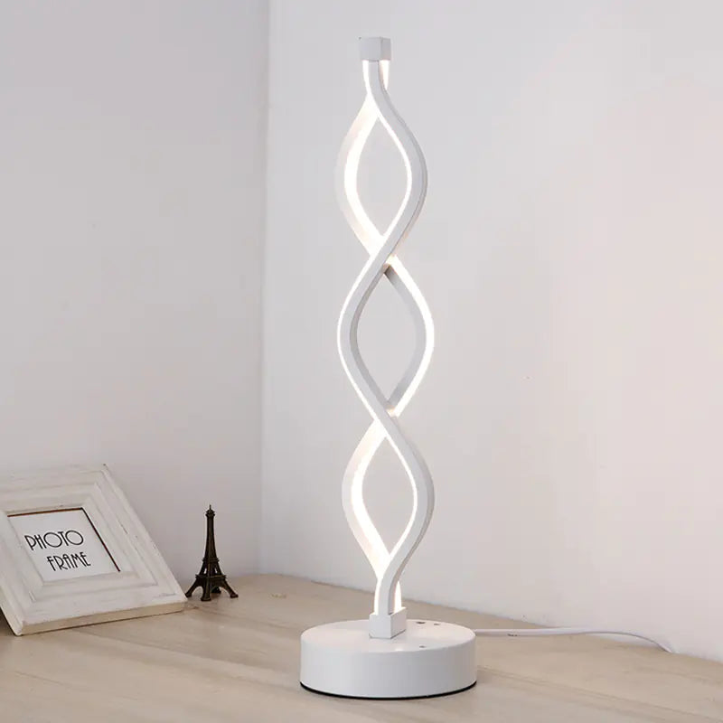 Acrylic LED Desk Lamp with white shell and white light, lit on a side table